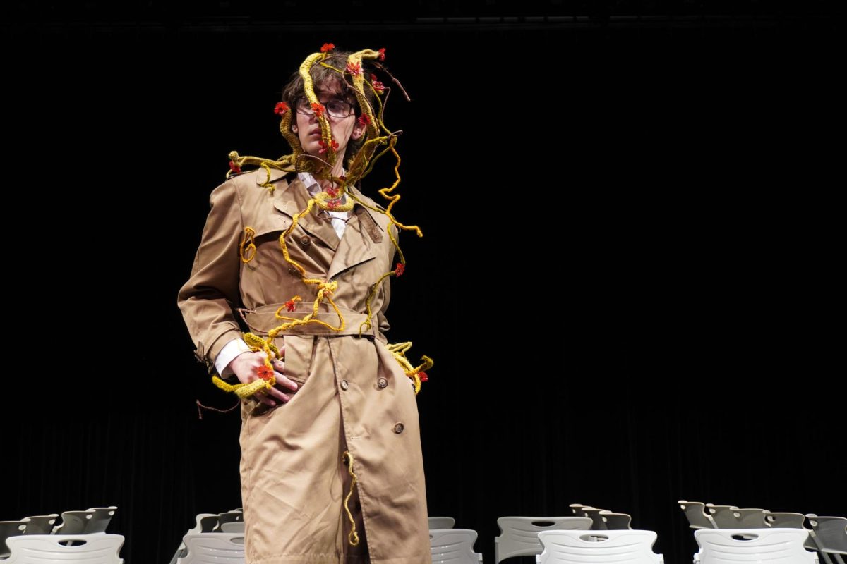 Senior Aidan Jeske models senior Kim Nguyen's piece for the Artist and Activist Wearable Art segment. Nguyen used found objects, yarn and wire for this piece.