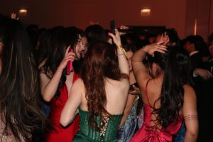After eating dinner, students make their way to the dance floor. The DJ plays songs to get the students excited and ready to dance with their friends. 