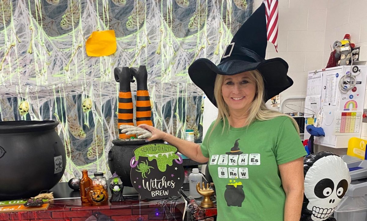 Protus poses with the Halloween decorations in her classroom. 