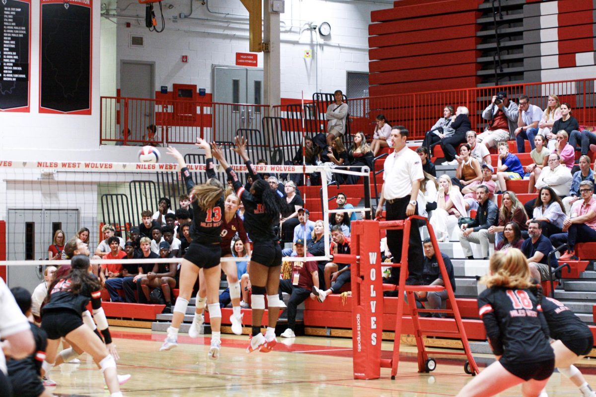 The Niles West Girls Varsity team trying they're best to force back game
 point against Loyola
 Academy Highschool.