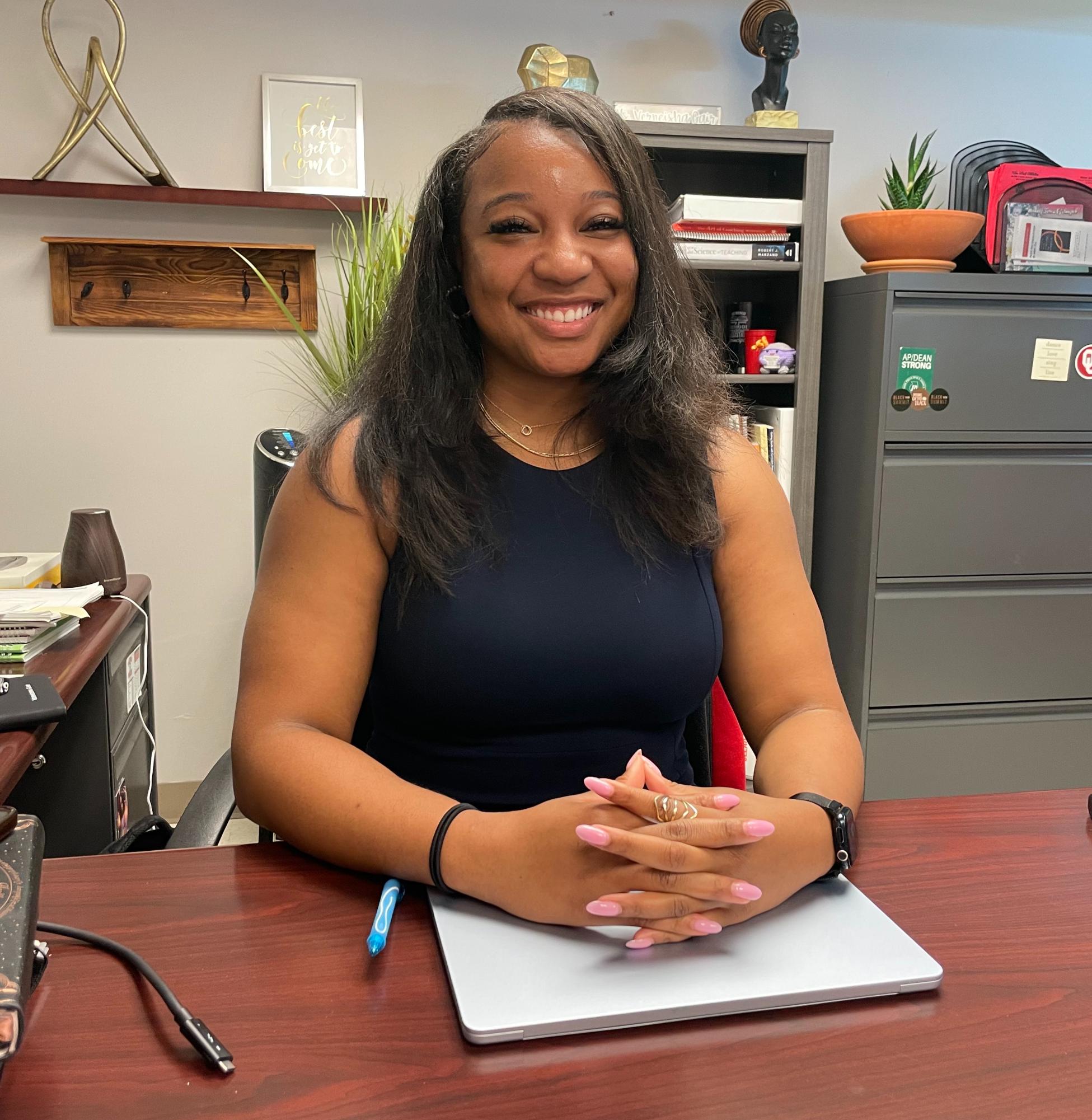 Assistant Principal of the class of 2027, Verneisha Gair, sits at her desk ready to greet students with a smile.