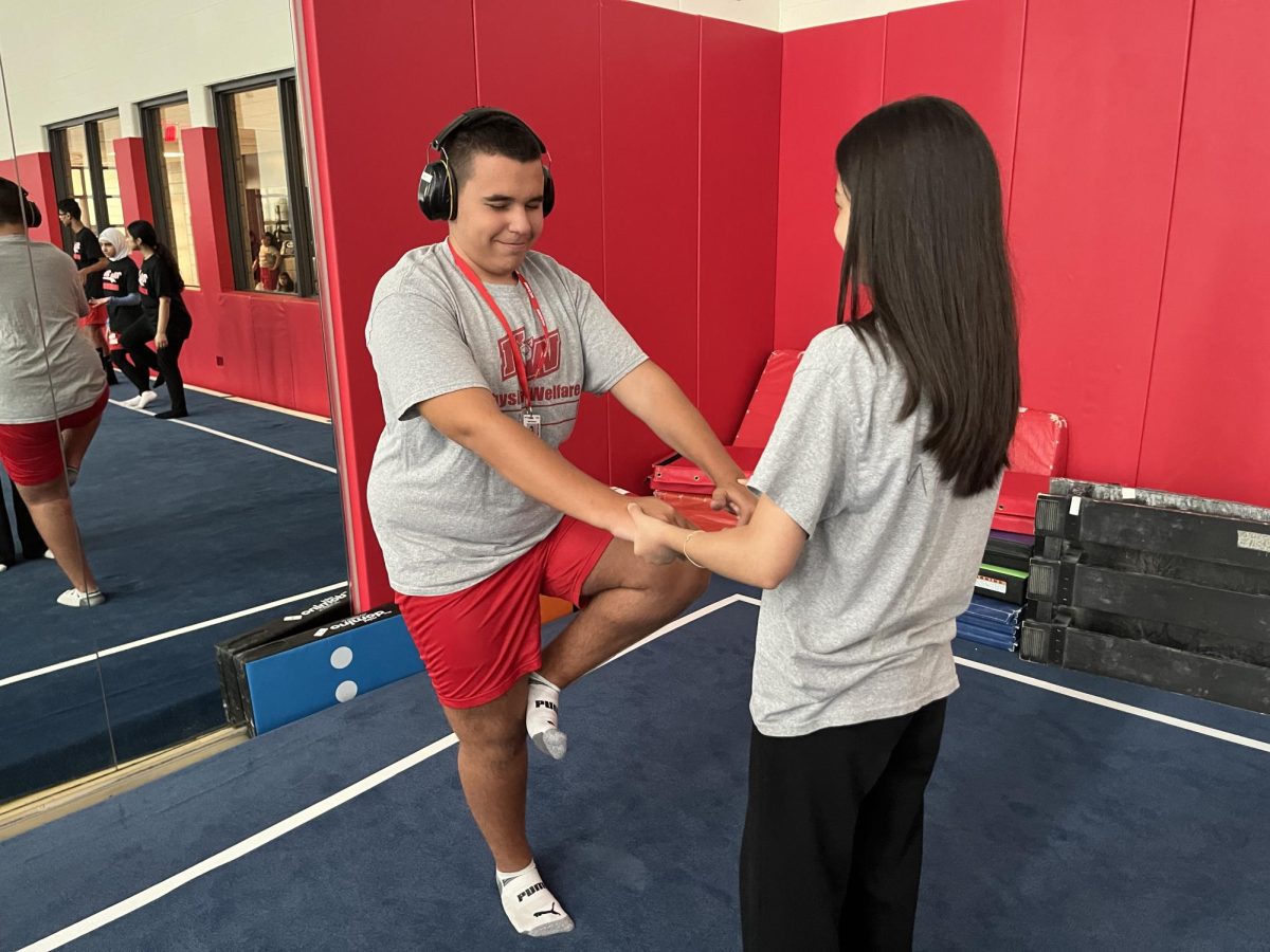 Senior Mariyam Yevaz Ali and sophomore Andi Breznica do yoga during 4th period Integrated PE. 
