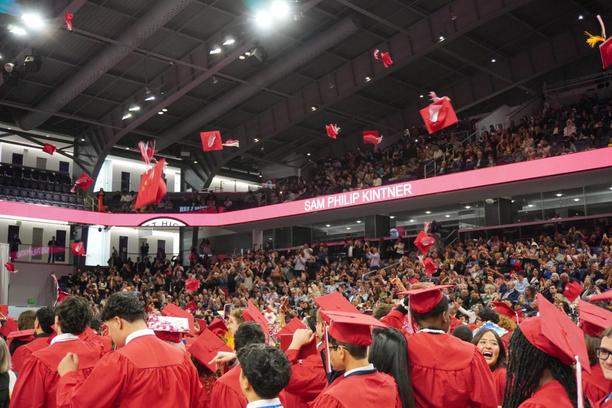 The Class of 2025 throw their caps into the air after receiving their diplomas. 
