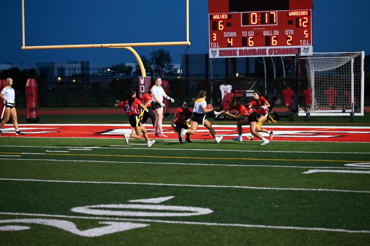  Several defenders sack a Maine West player to prevent a touchdown. They get a stop inches before the endzone.
