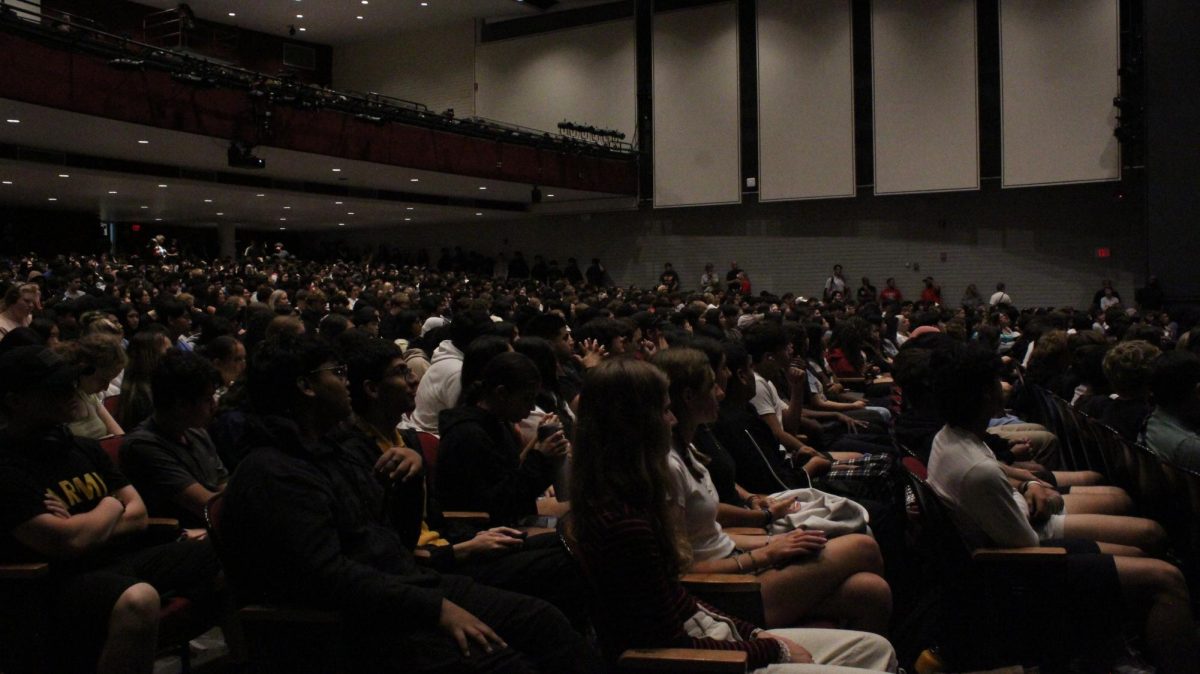 Students sit in the auditorium as an assembly commences. 