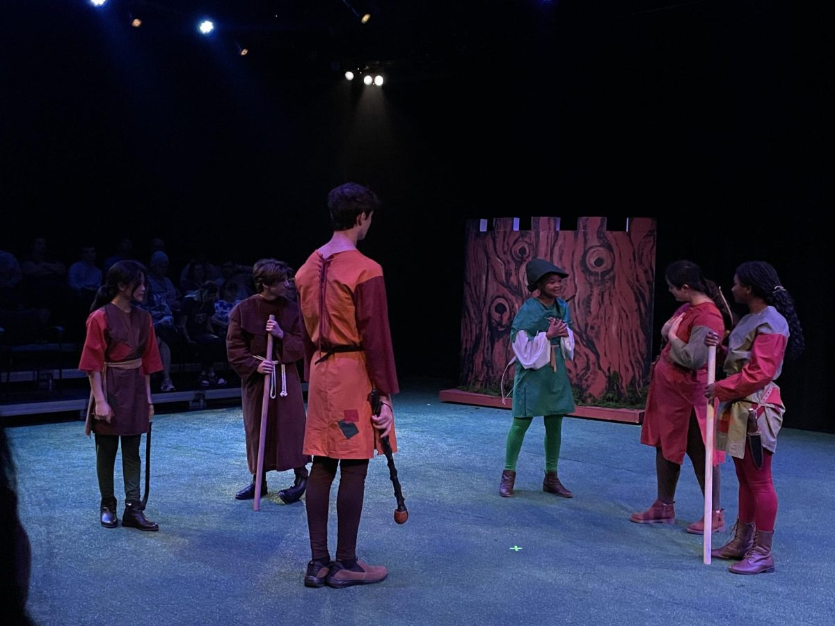 Victoria HooSang, senior, as Robin Hood, Matas Meistininkas, junior, as Little John, Emma Shimon, J Saxon-Joseph and Cole Schaefer-Feldman share a heartwarming moment as the merry men. This show explores themes about identity and love.