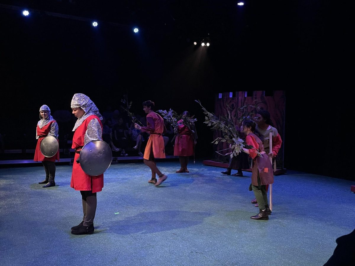 The group of merry men sneaks behind the guards played by Natalie Logan and Ruby Dembo. They plan to attack them.
