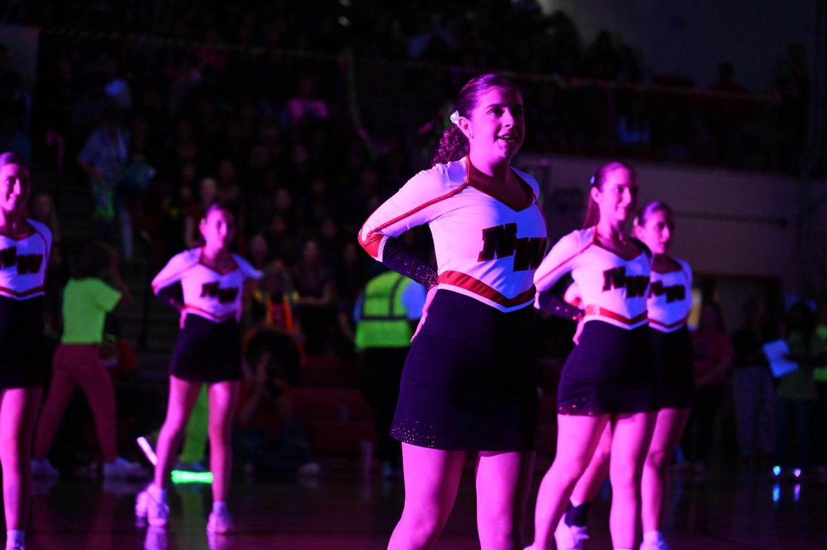 Gabi Raskaj, junior, performs with the dance team as the homecoming assembly continues.