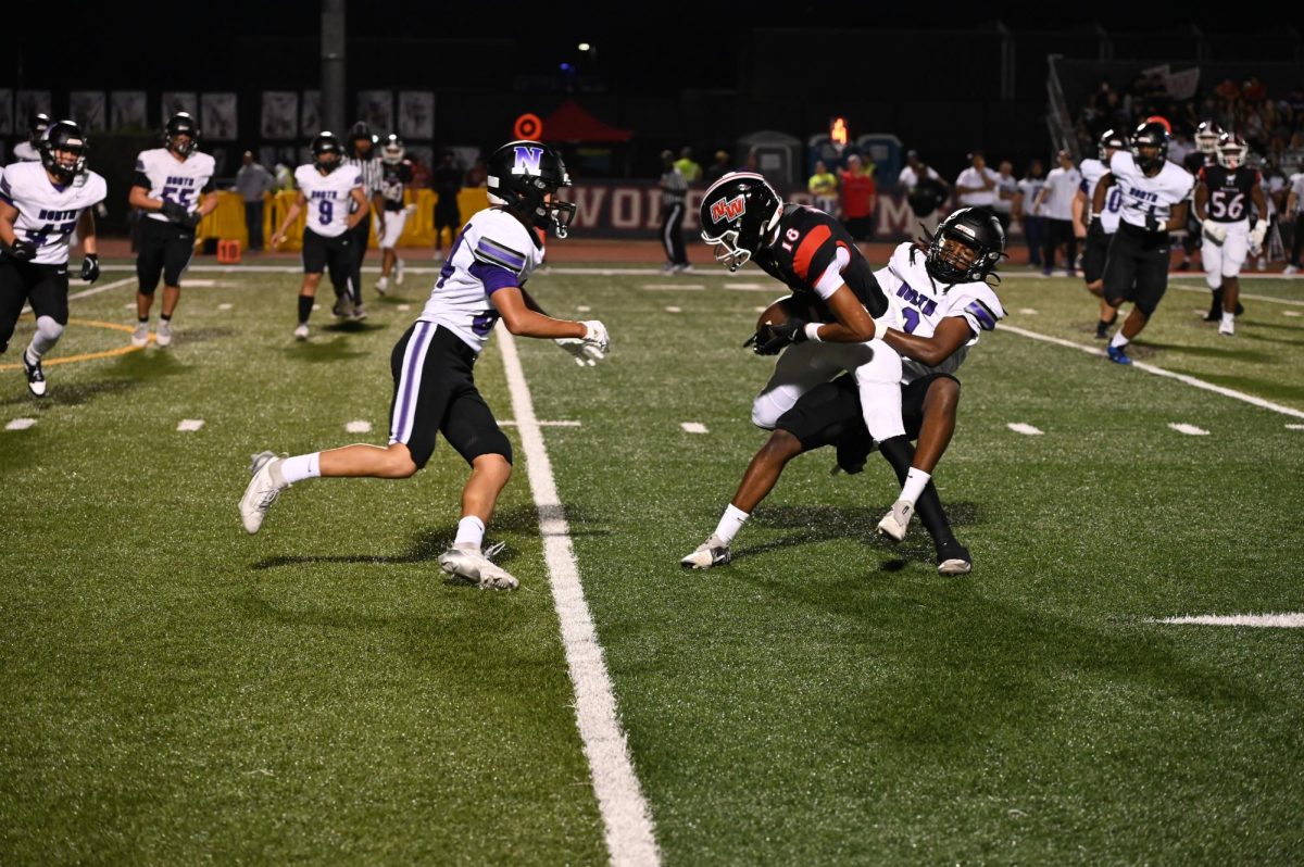 Sebastian Baptista, senior, catches pass from Quarter Back Nick West senior, for the first down.