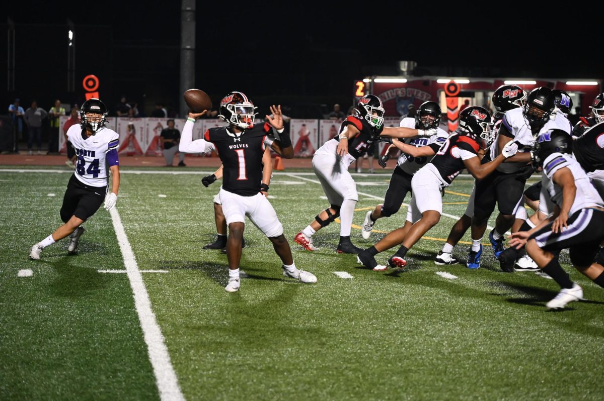 Nick West senior,  drops back to pass the ball to his open Wide receiver.