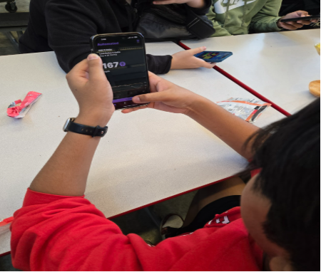 During lunch, Shameel Tabassum, freshman, monitors his glucose levels after he eats so he knows whether or not he should put insulin on.
