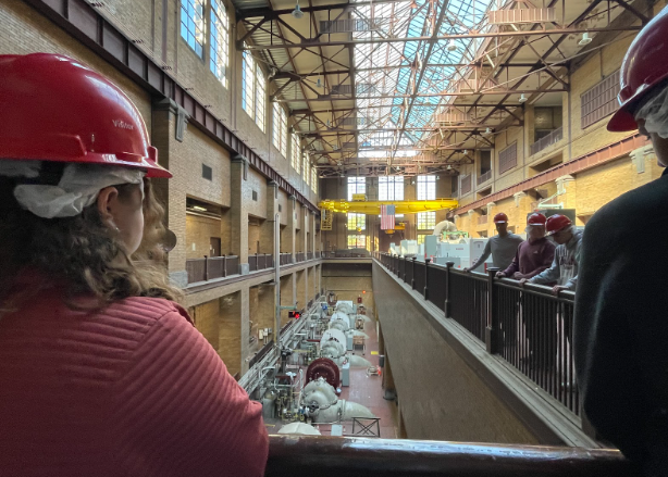 Charlotte Herbert, senior, looks at machines in the O'Brien Water Reclamation Plant, which perform the first phase of getting out big debris from water. 
