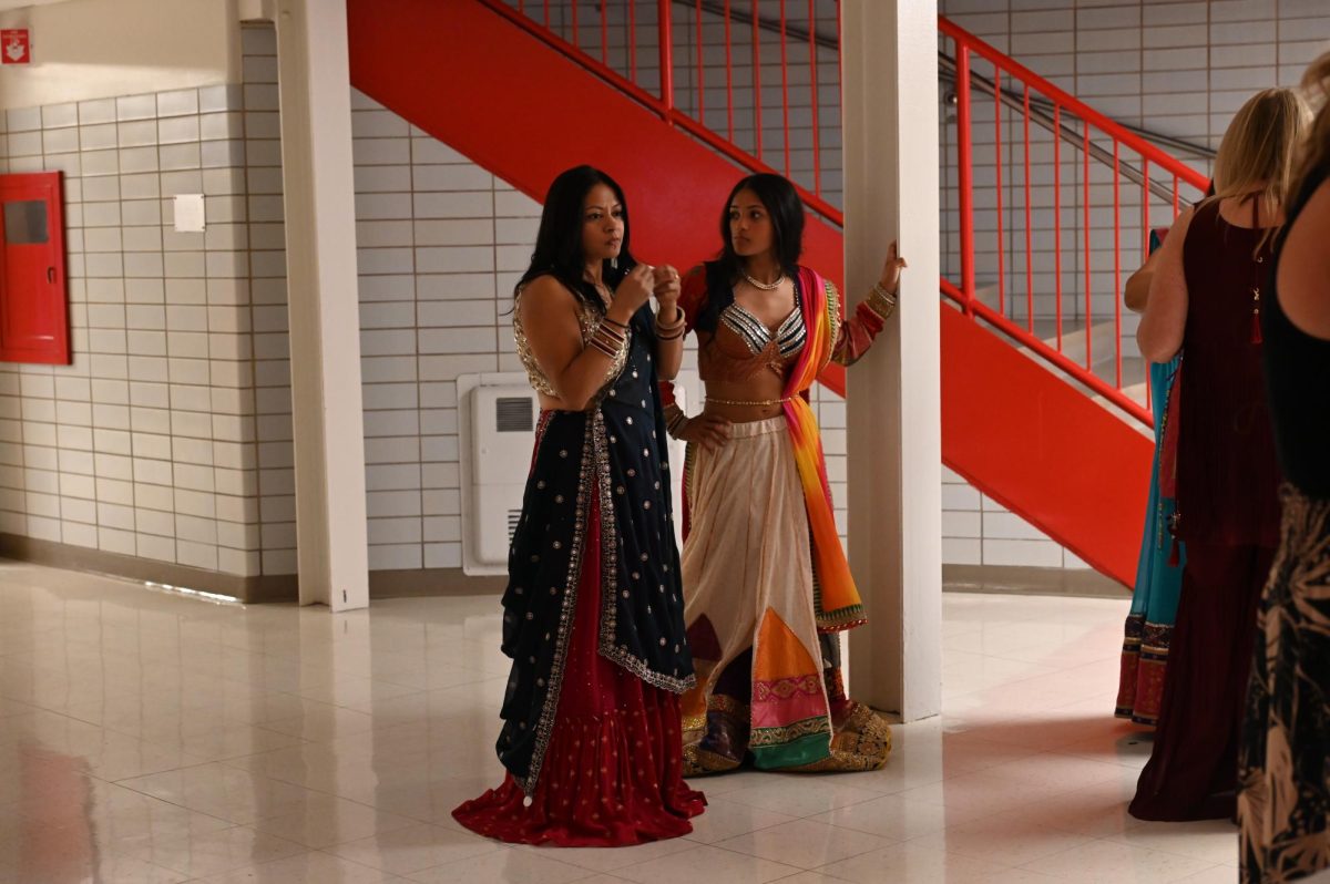Attendees enjoy refreshments and samosas outside the gym. 