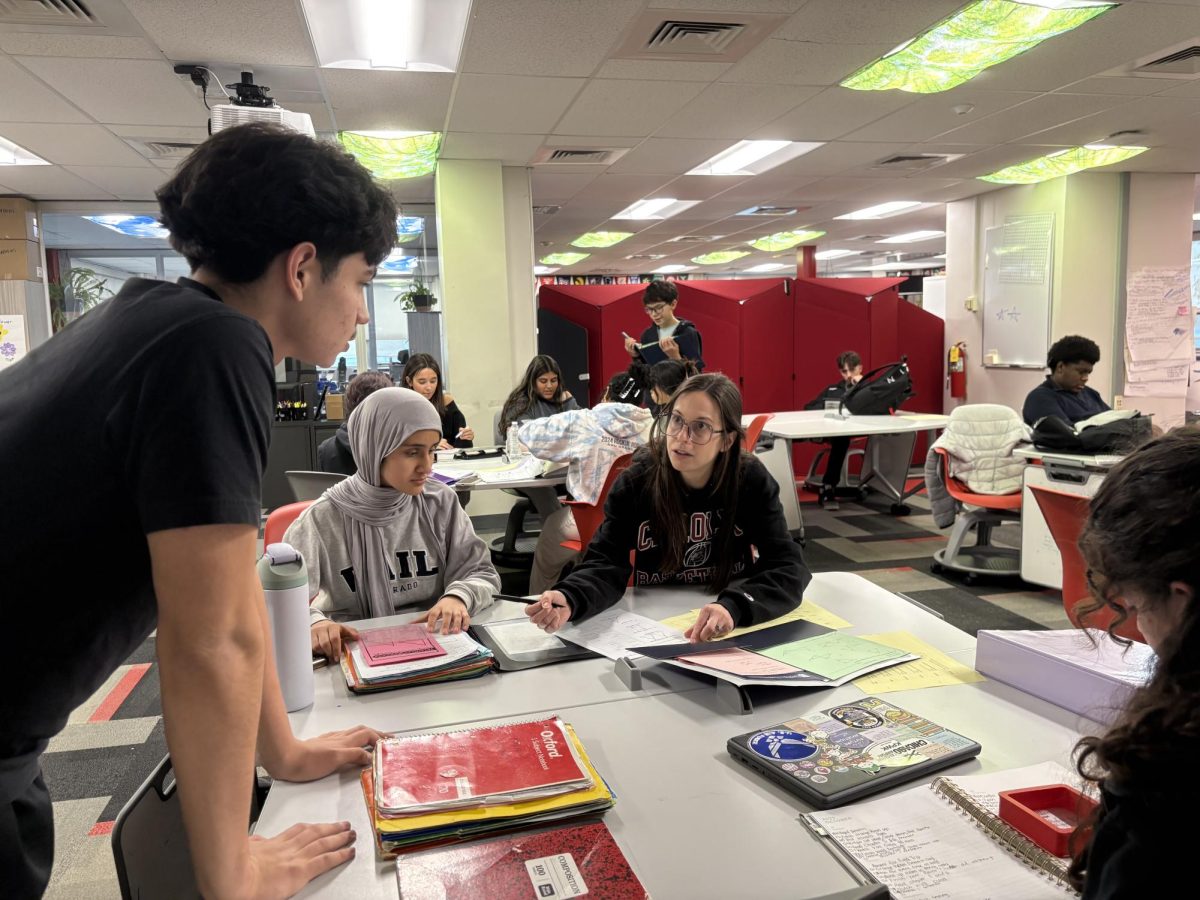 Lisa Heller helps student with their assignment.