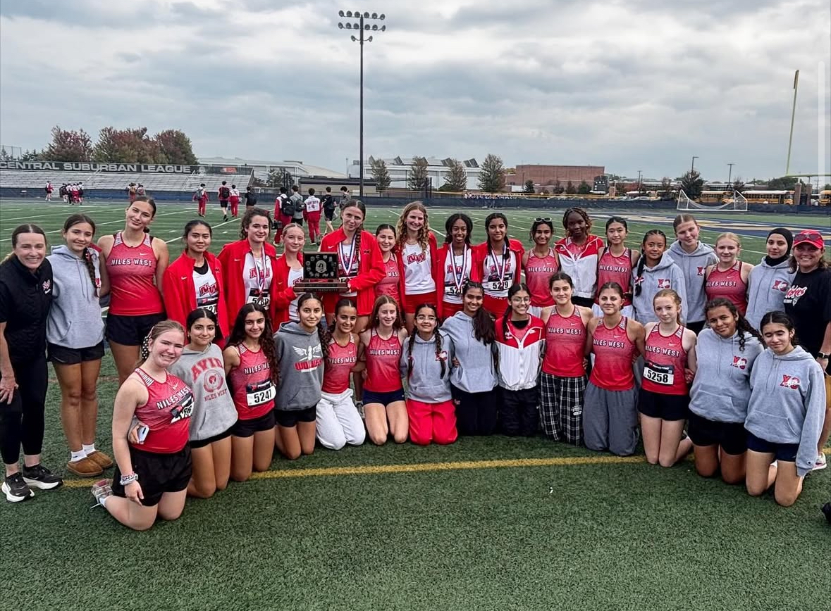 The girls cross country team poses with the CSL-North trophy, alongside four athletes showing their medals after being named All-Conference at the CSL meet on Oct. 18 at Glenbrook South High School. Photo via @nw_gxc on Instagram