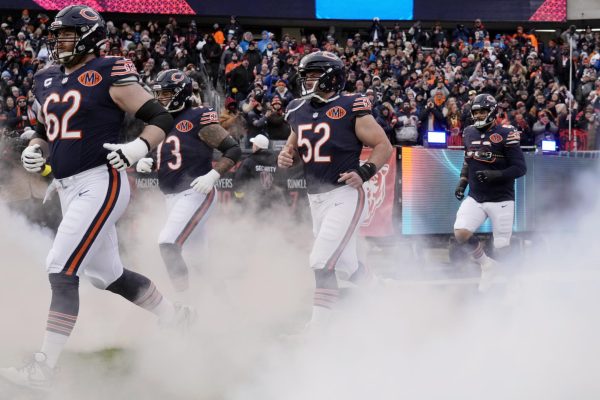 Jan 4, 2026; Chicago, Illinois, USA; Chicago Bears guard Joe Thuney (62) and center Drew Dalman (52) run onto the field before the game between the Chicago Bears and the Detroit Lions at Soldier Field. Mandatory Credit: David Banks-Imagn Images