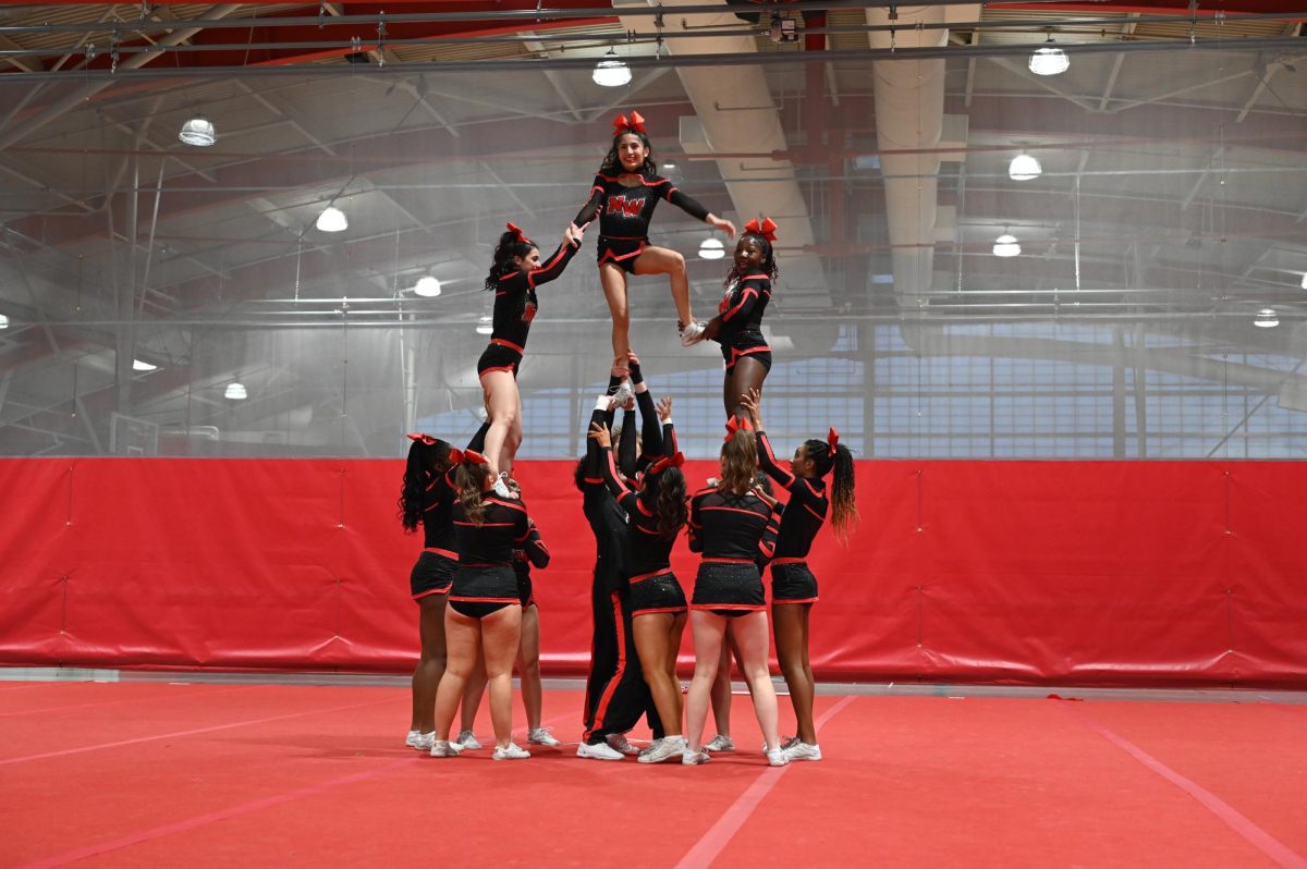 Varisty Co-Ed cheer runs through their performance before competing for the annual Niles West Cheer Fest on Jan. 18. With 57 performances, Niles West was the final show of the night. 