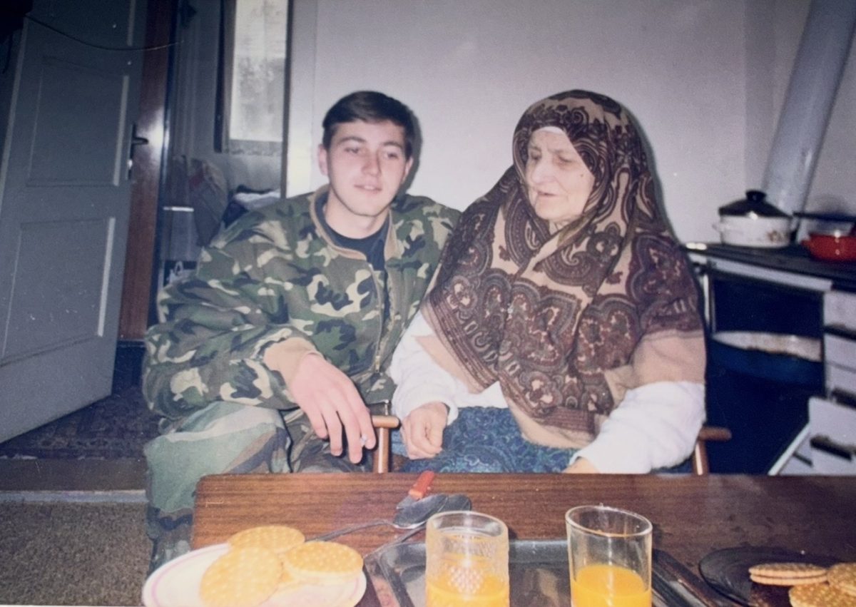 On the left, Damir Mahic poses with his grandmother while visiting her during the war.