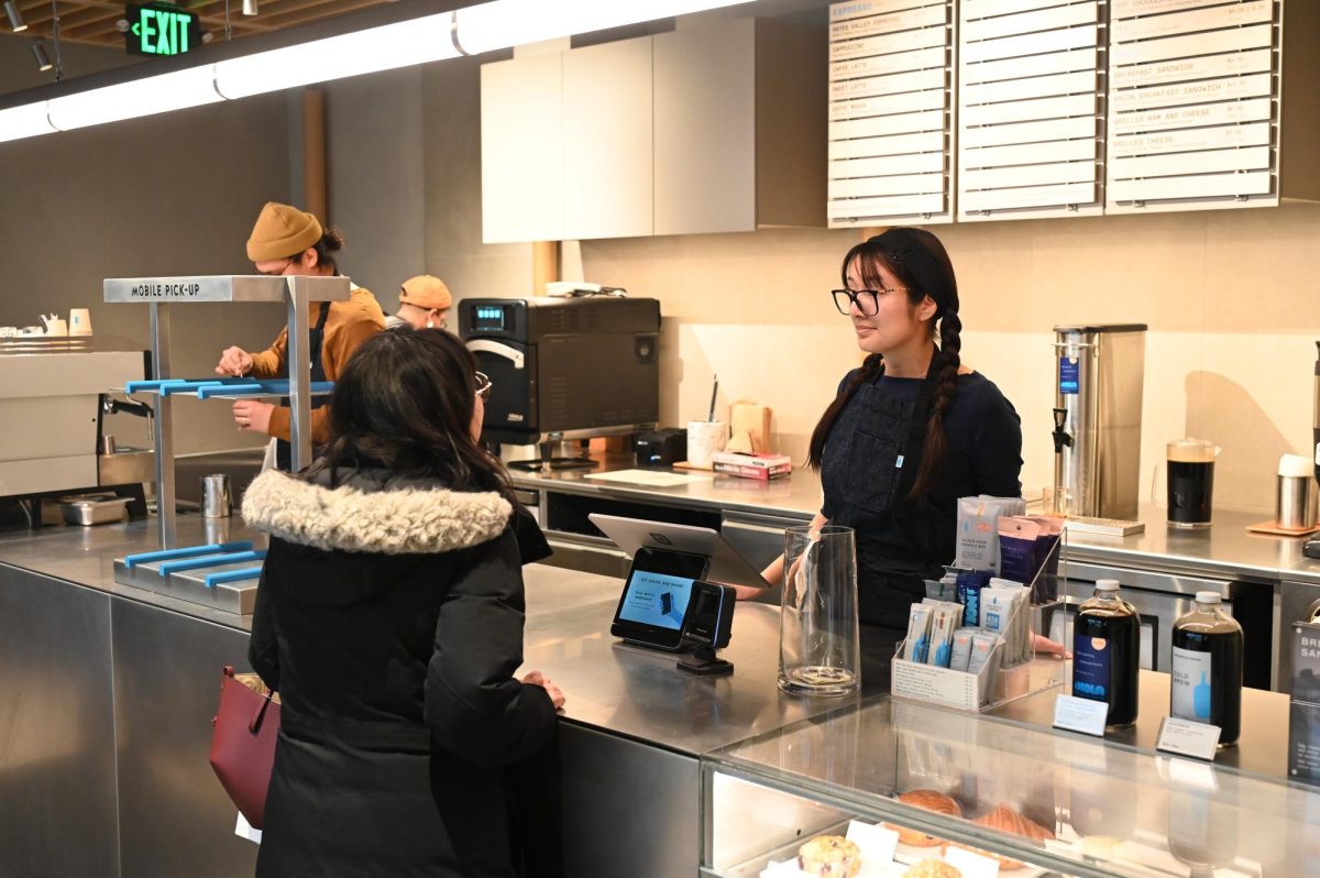 Worker, Brianna Bello, interacts with a customer as they decide what they would like to have.