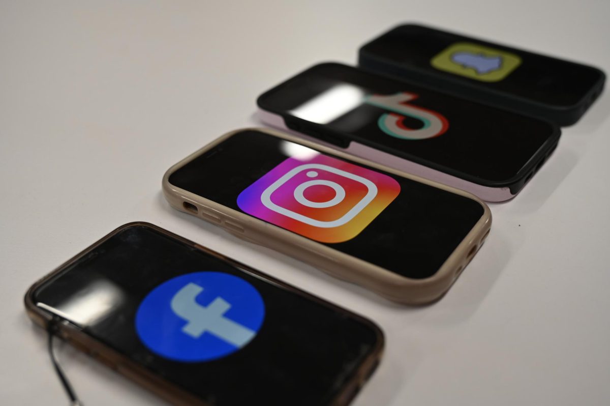 The phones are lined up as social media application logos are on screen.