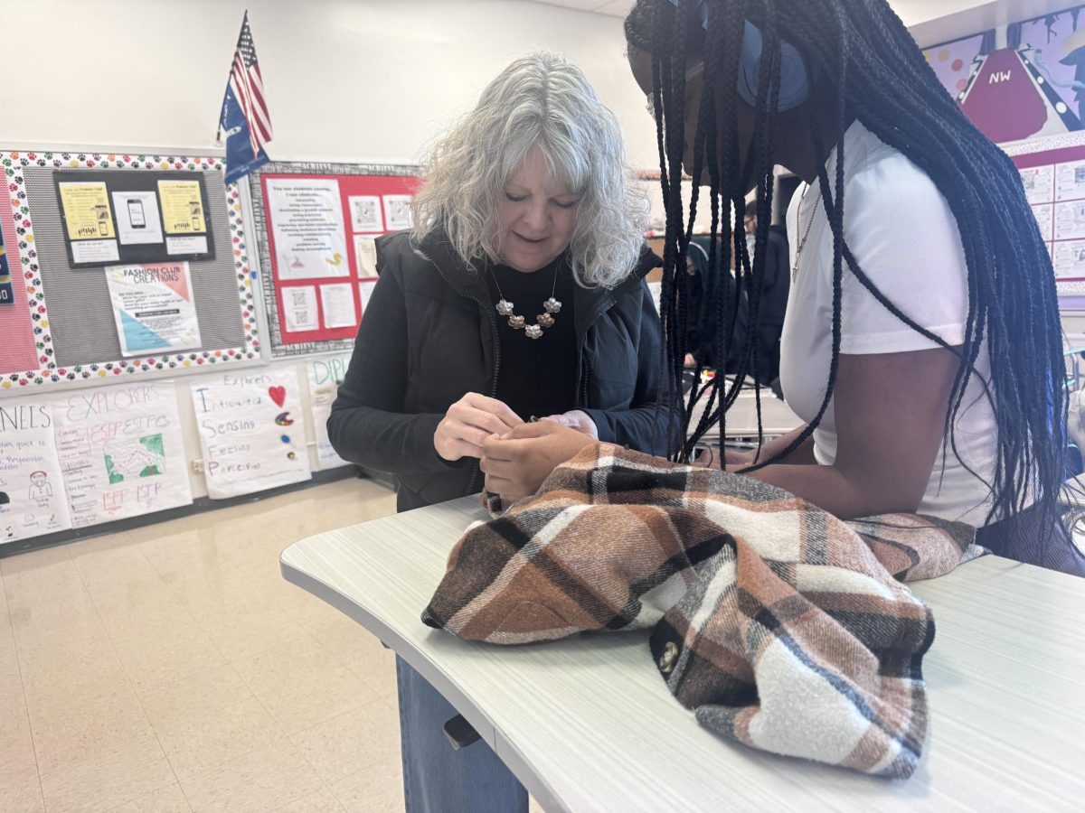 Michelle Kline assists her students through their sewing process. 