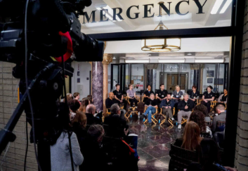 This photo peeks through a window, letting us take a look at the cast of "The Pitt." 