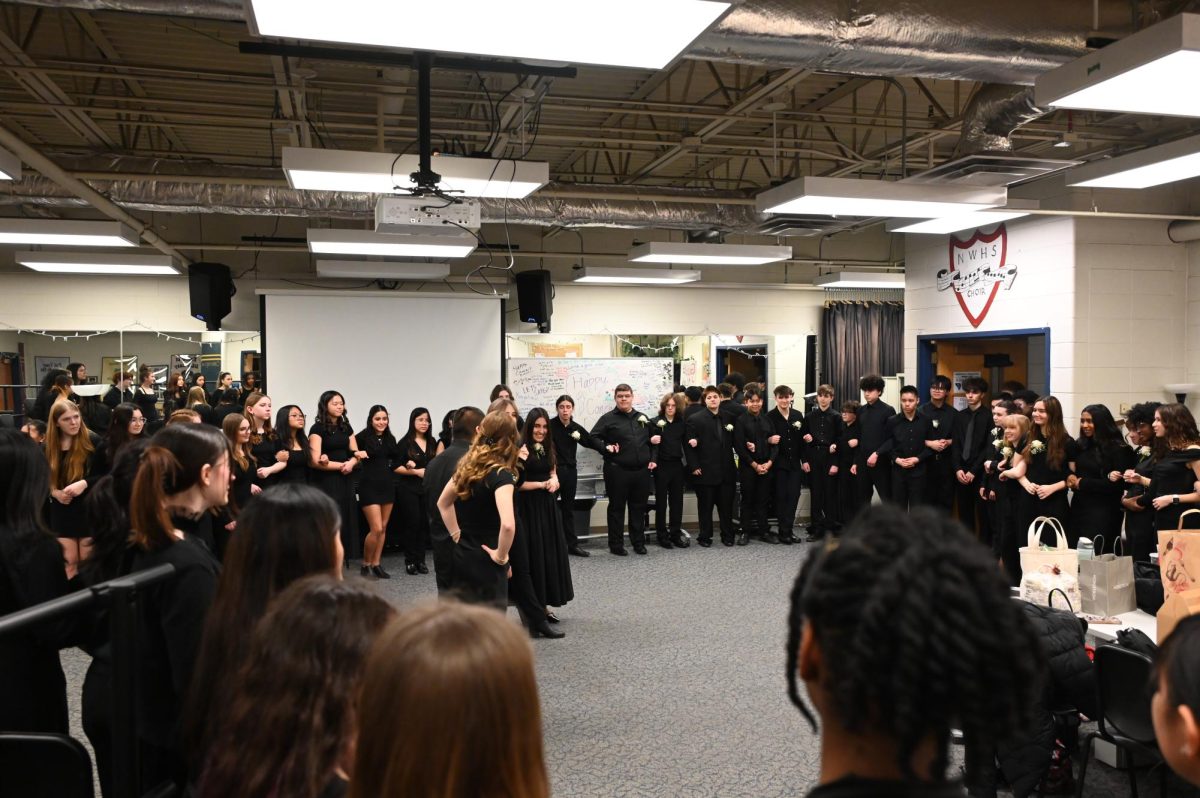 All of the choir members do their "Squeeze" ritual before the concert starts.