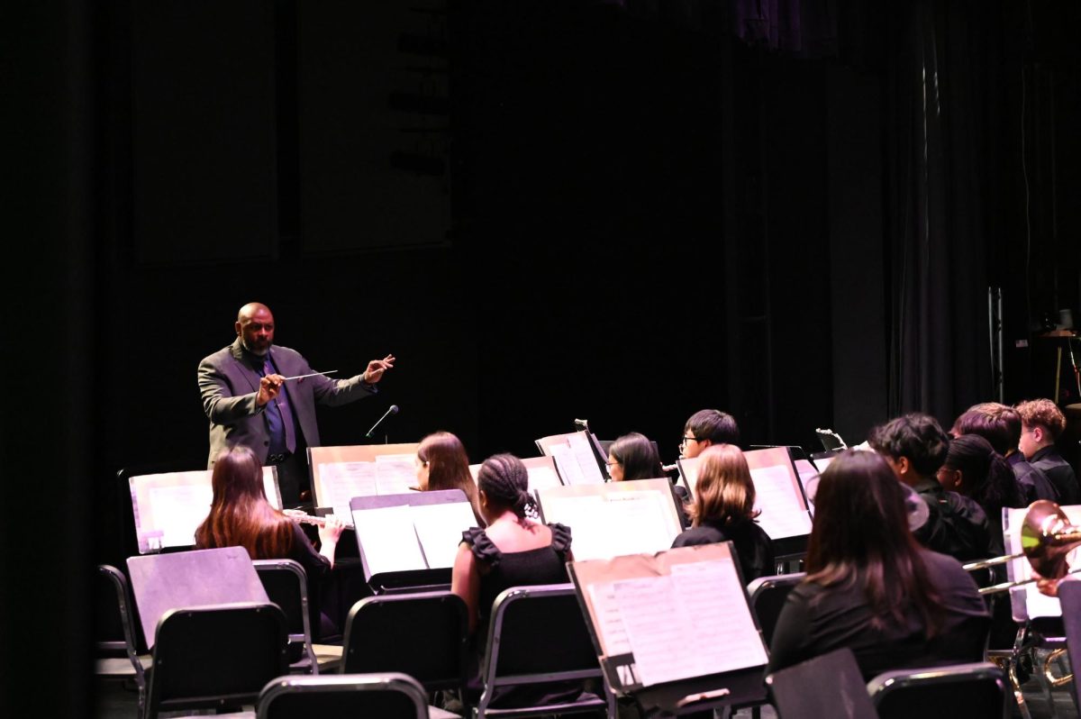 Band director Justin Johnson directs warmups for the Niles West Concert Band.