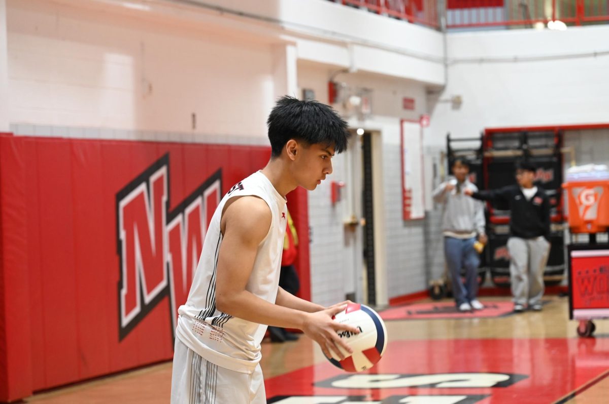 Leander De Vera, sophomore, performs his serving ritual in the first set against the Titans. 