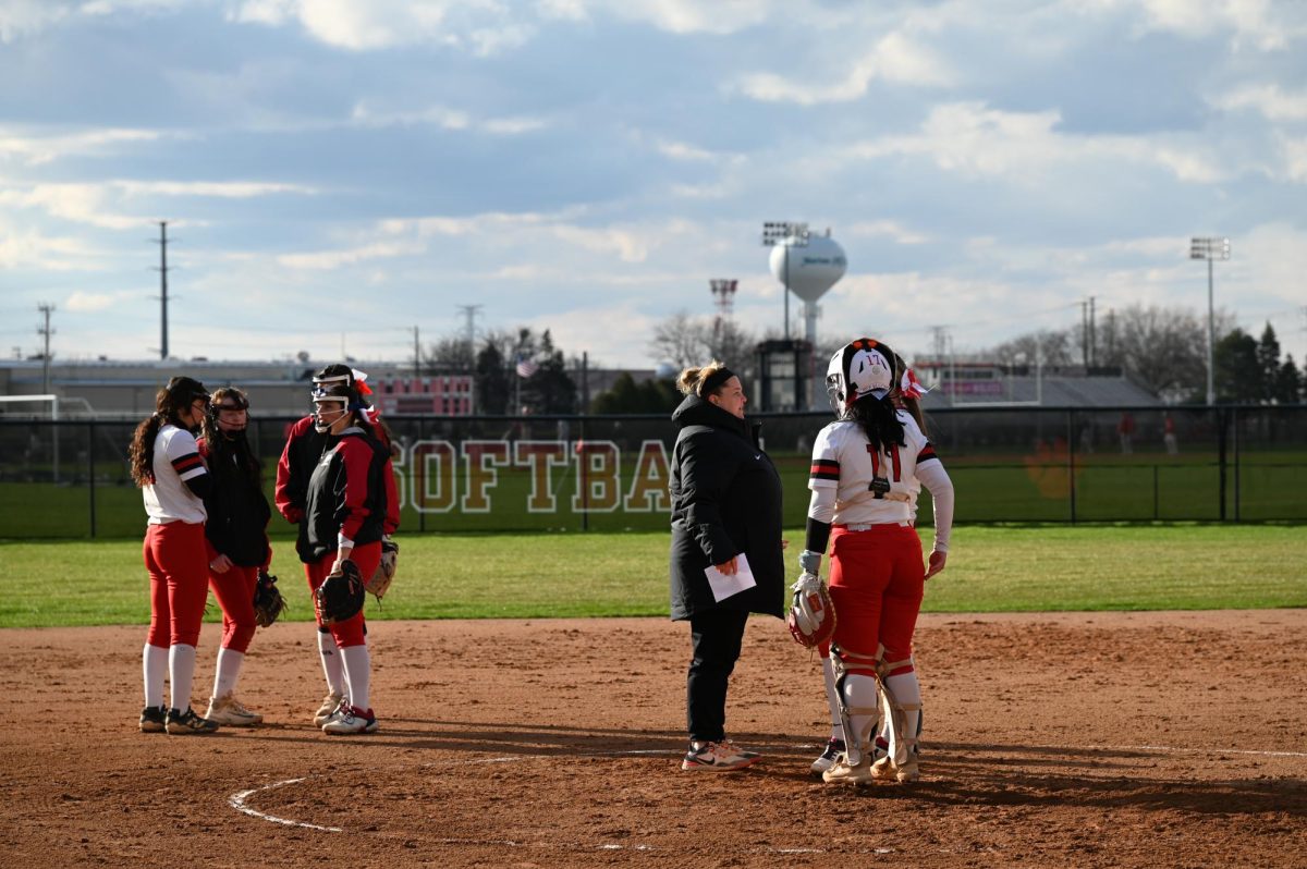 During a timeout, two separate groups huddle to talk about the game. 