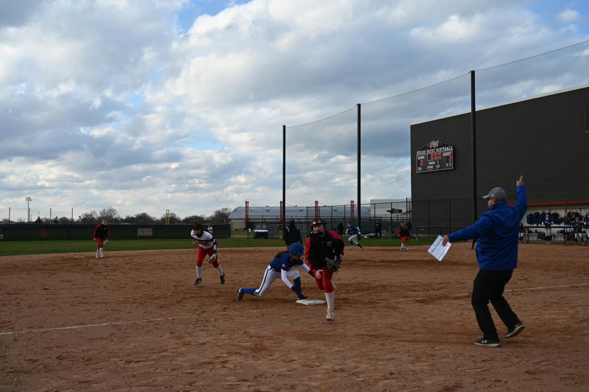 Sophmore, Ava Kolbe, running to catch a ball at third base. 