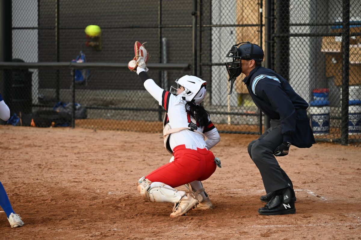 Catcher Ava Hortega, senior, receives the softball during an active play. 