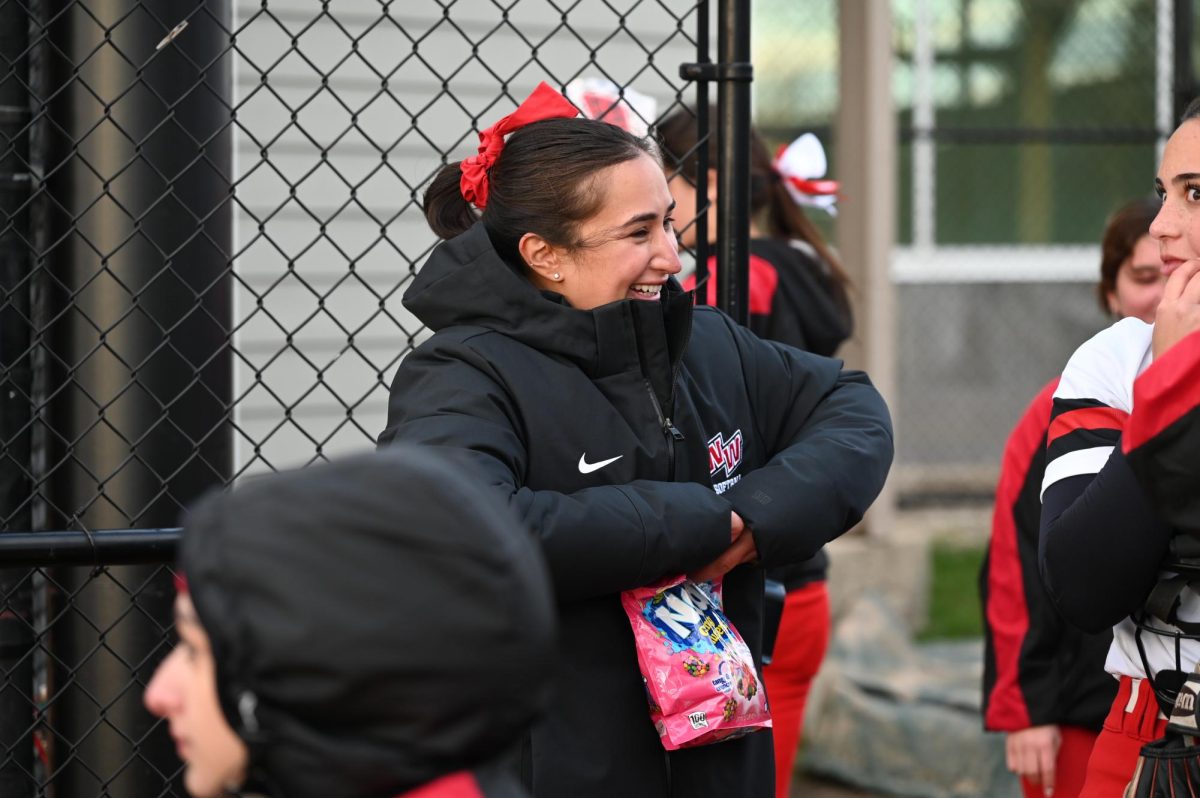 Coach Maya giving candy to her players after they finish playing.