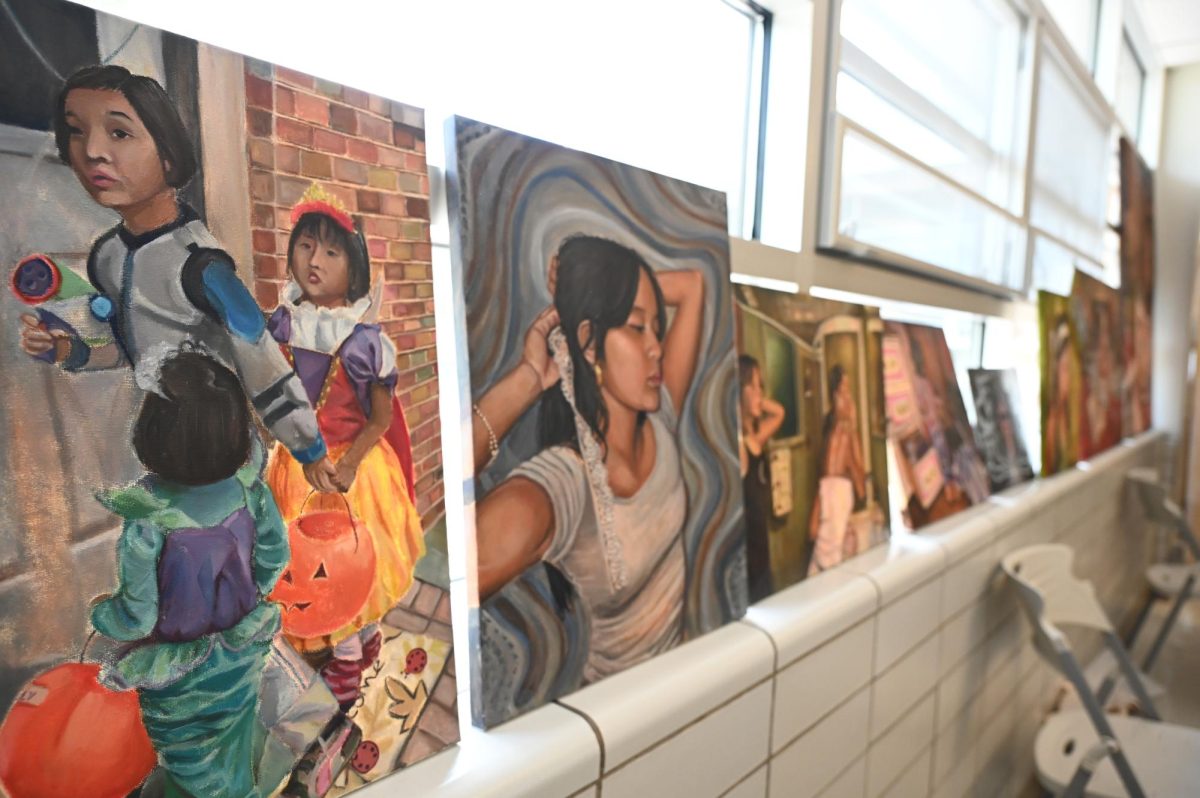 On April 28, the Fine Arts Department held an AP Hallway show for all seniors as a way to showcase their portfolios and art collections. One of the students, Ally Nguyen, senior, displays her art collection of oil paintings. 