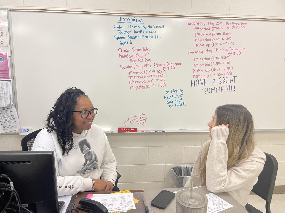 Nedra Walker talks to junior Bianca Fratila in the testing center. 