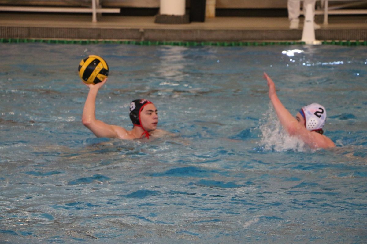 Ayden Lear, senior, passes the ball through their opponents attempted block.