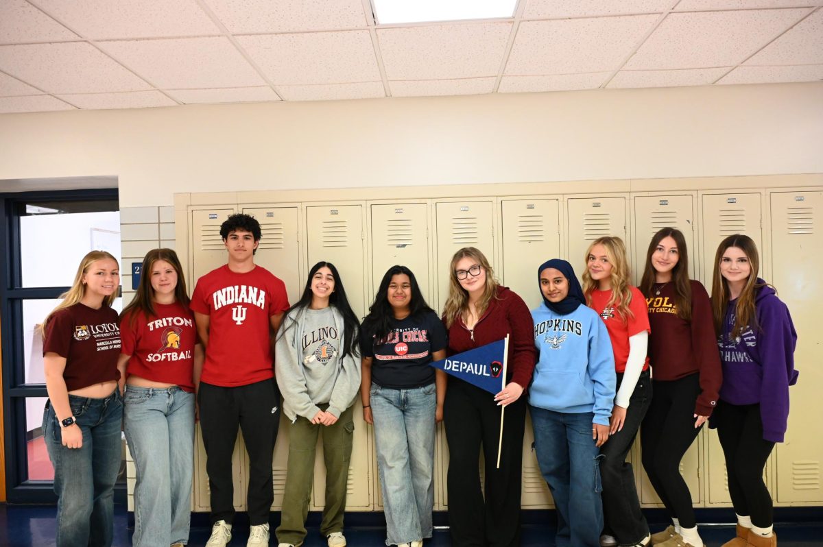 From left to right seniors Holly Korzun, Ava Hortega, Joaquin Lannoye, Suha Siddiqui, Sarina Nur, Alex Mocarska, Aishah Khan, Brianna Calin, Ayla Mahic and Cora Gayford stand in front of the lockers to display the universities they will be attending next school year. 