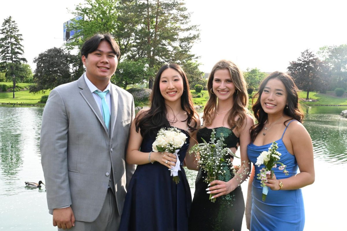 From left, Jeffery Le, Ellie Kim, Talia Spector and Christine Vuong, seniors, take photos at Dunne Park. Prom was held at the Loews Chicago Hotel on May 16.