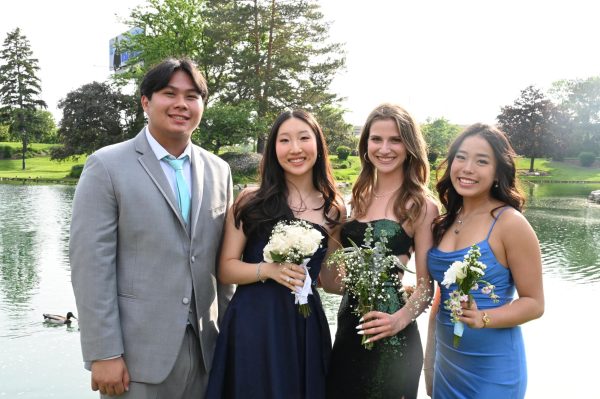 From left, Jeffery Le, Ellie Kim, Talia Spector and Christine Vuong, seniors, take photos at Dunne Park. Prom was held at the Loews Chicago Hotel on May 16.