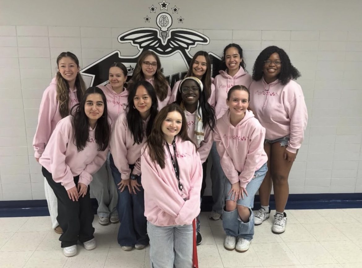 Members of the fine arts council and sponsor MK Guthrie pose together in uniform merchandise. Photo via @nwfineartscouncil on Instagram.
