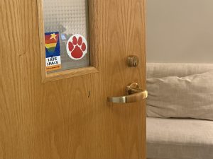 A "Safe Space" sticker appears on a door inside the student services office.