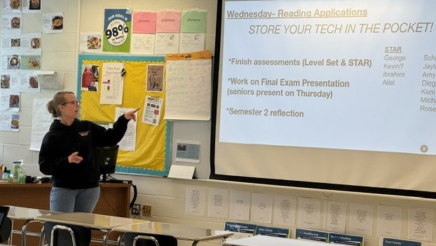 Retiring English and reading teacher Denise Whitefield explains the class agenda to her students. 