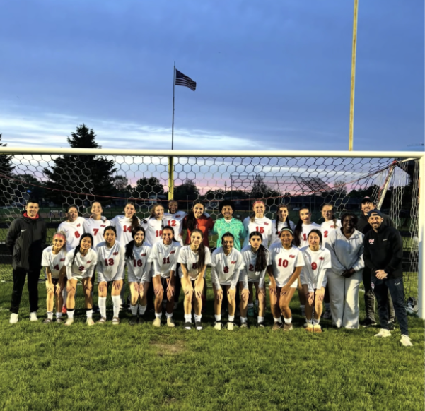 Girls varsity soccer pose after winning their game against Maine East. Image via nileswestathletics on Instagram