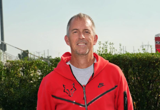 Wilson poses for his tennis picture. He has coached tennis for 30 years.